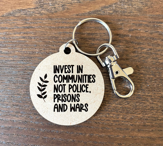 Invest in communities not police prisons and wars keychain